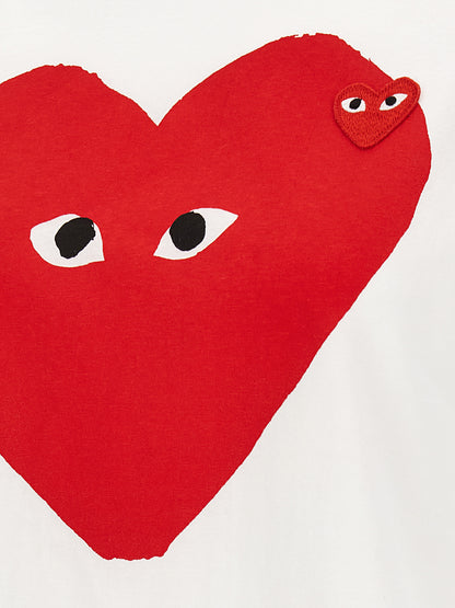 T-Shirt by Comme Des Garçons Play for women in cotton red, white & print showcases a unassuming silhouette, artfully detailed with a refined and unassuming for a sophisticated, contemporary look.