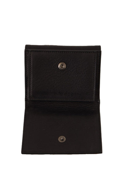 Wallet by Dolce & Gabbana for women in leather black showcases a discerning silhouette, artfully capturing the essence of Leather Wallet with its functional compact-design trifold.