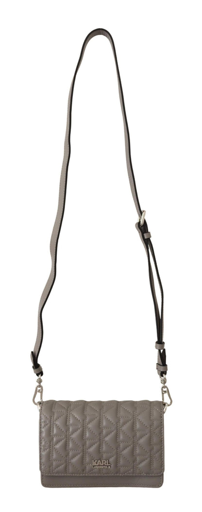 Travel Crossbody Flap Convertible Handbag by Karl Lagerfeld for women in leather gray, light-grey & silver features an exquisite silhouette, showcasing a secure snap, flap & zipper, ample built-in-compartments, and exquisite crossbody-strap, shoulder-strap & adjustable-strap for a sophisticated finish.