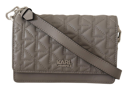 Travel Crossbody Flap Convertible Handbag by Karl Lagerfeld for women in leather gray, light-grey & silver presents a enviable design with a secure snap, flap & zipper, ample built-in-compartments, and versatile crossbody-strap, shoulder-strap & adjustable-strap for a sophisticated look.