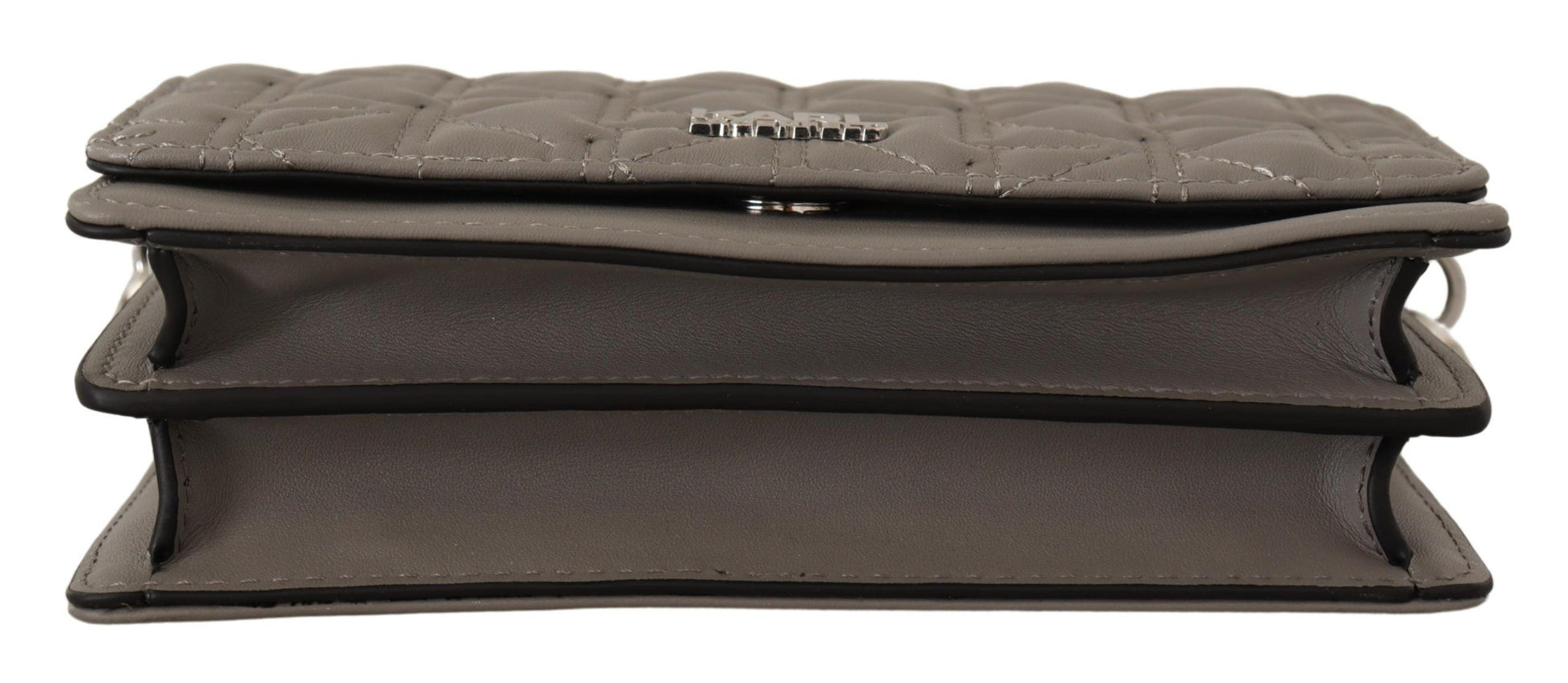 Travel Crossbody Flap Convertible Handbag by Karl Lagerfeld for women in leather gray, light-grey & silver features a exquisite silhouette with a secure snap, flap & zipper, ample built-in-compartments, and versatile crossbody-strap, shoulder-strap & adjustable-strap for a exquisite look.