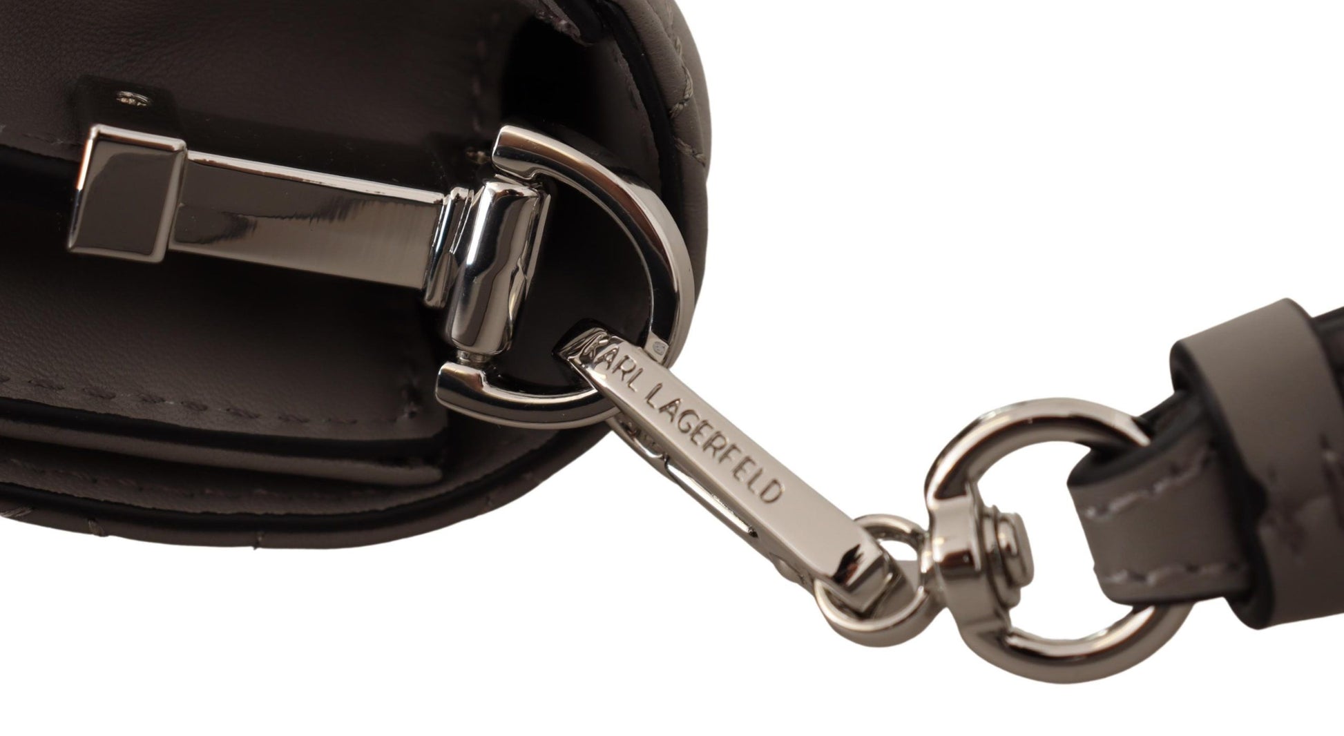 Travel Crossbody Flap Convertible Handbag by Karl Lagerfeld for women in leather gray, light-grey & silver features a refined silhouette, showcasing a secure snap, flap & zipper and refined built-in-compartments with versatile crossbody-strap, shoulder-strap & adjustable-strap for a refined finish.