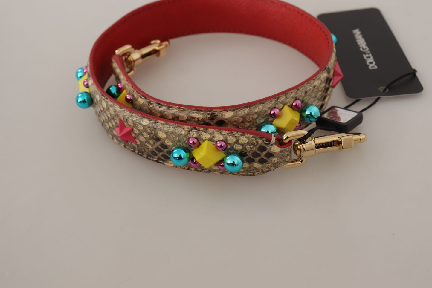 Shoulder Strap by Dolce & Gabbana for unisex in python leather & crystal beige & gold features a dynamic silhouette, artfully enhancing the dynamic design of this Python Leather Crystal Shoulder Strap.