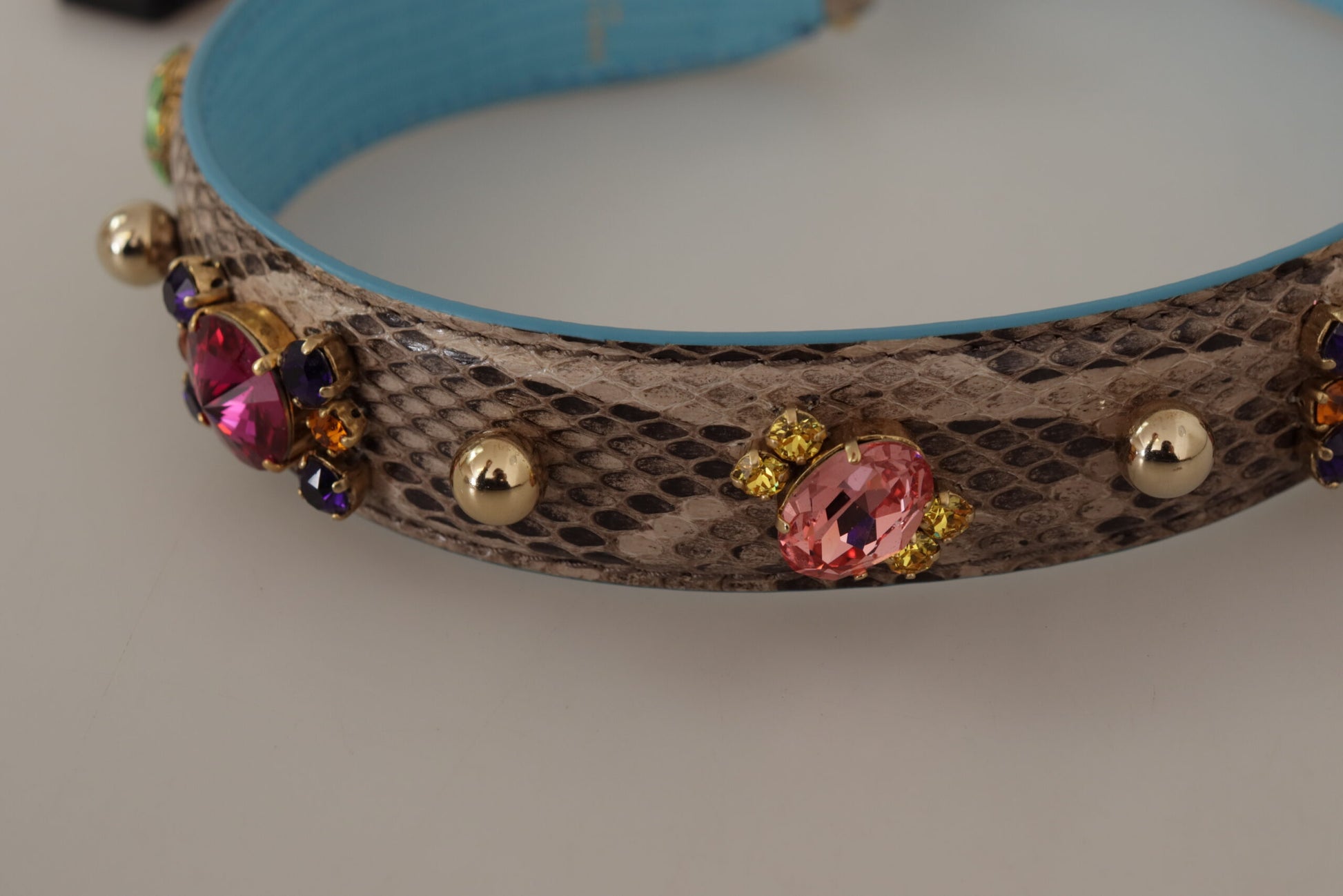 Shoulder Strap by Dolce & Gabbana for unisex in exotic leather & crystal brown & gold features a dynamic silhouette, artfully enhancing the dynamic design of this Exotic Leather Crystal Shoulder Strap.