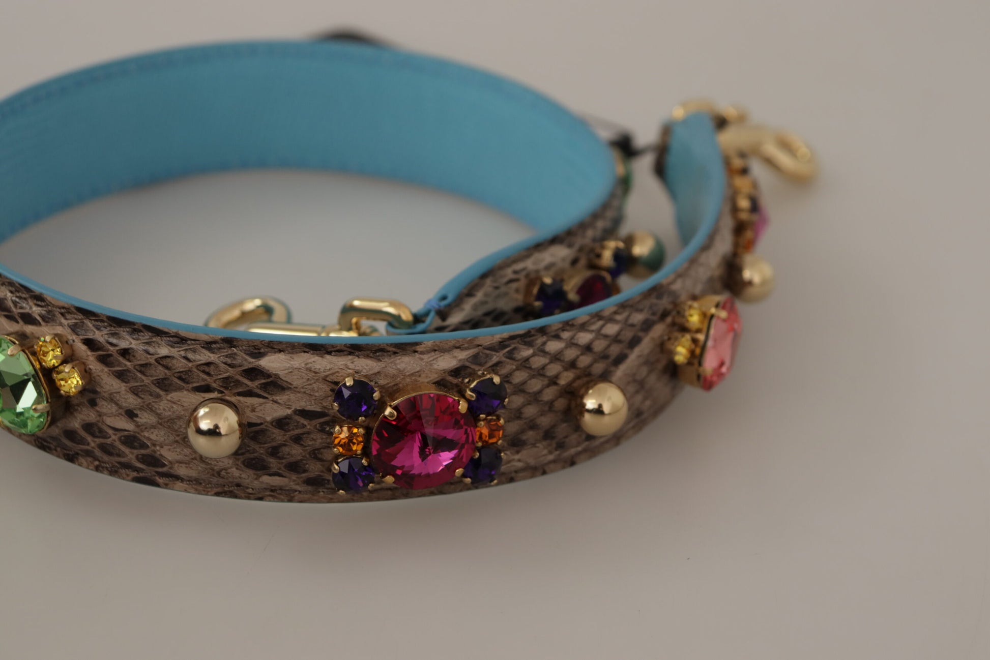 Shoulder Strap by Dolce & Gabbana for unisex in exotic leather & crystal brown & gold features a contemporary design, highlighting the distinctive style of the Exotic Leather Crystal Shoulder Strap with a contemporary finish.