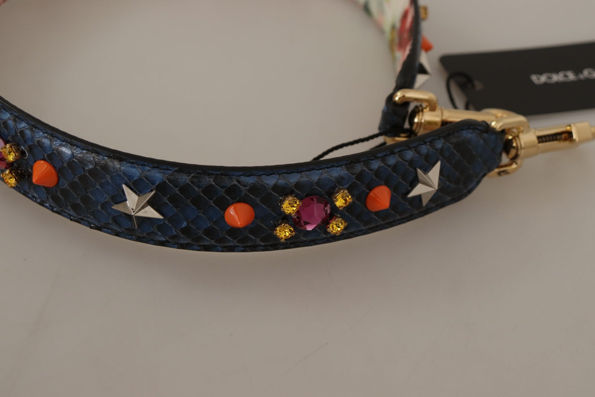 Shoulder Strap by Dolce & Gabbana for unisex in exotic leather & crystal blue & gold features an stylish design, beautifully completing the signature look of the Exotic Leather Crystal Shoulder Strap.