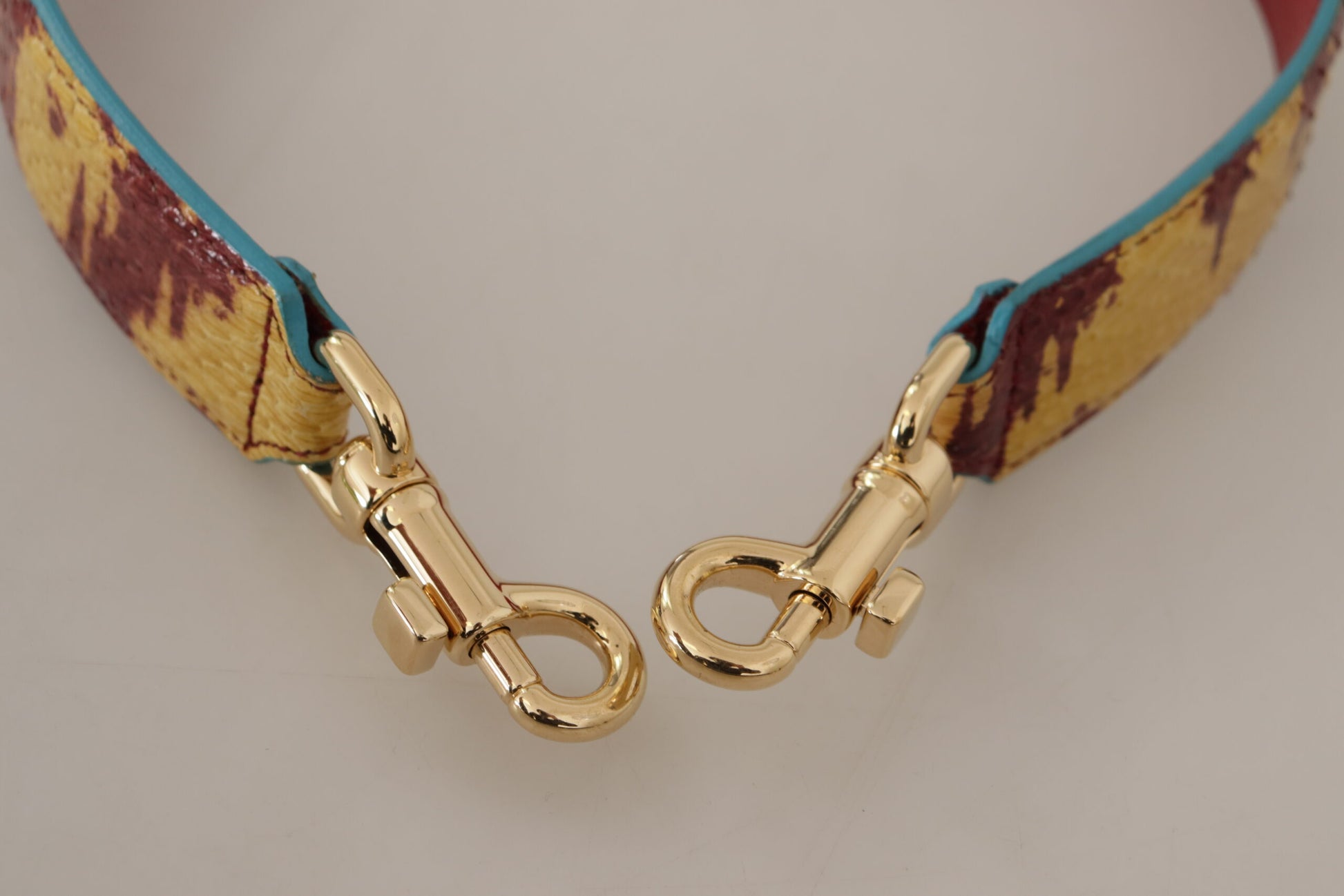Shoulder Strap by Dolce & Gabbana for unisex in ayers calf leather gold, red & yellow showcases a enviable design, perfect for elevating any ensemble as part of the Ayers Calf Leather Shoulder Strap collection.