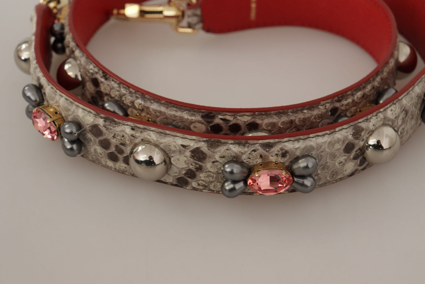 Shoulder Strap by Dolce & Gabbana for unisex in python leather beige & gold features a effortlessly chic design, perfectly complementing the signature look of the Python Leather Shoulder Strap.