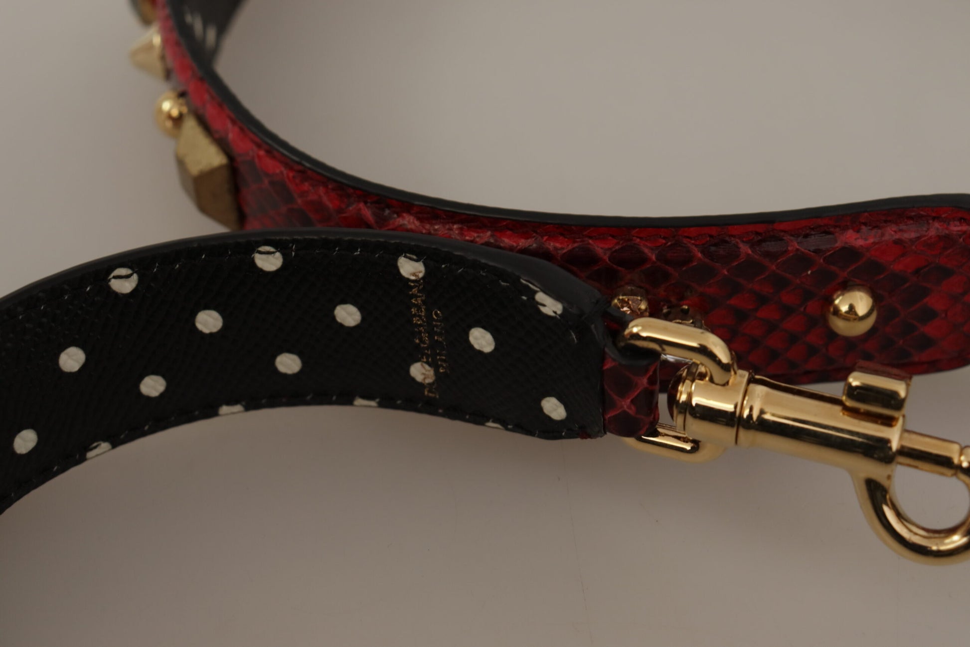 Shoulder Strap by Dolce & Gabbana for unisex in python leather & crystal black, gold & red features a chic design, presenting a refined view of the Python Leather Crystal Shoulder Strap with a chic finish.