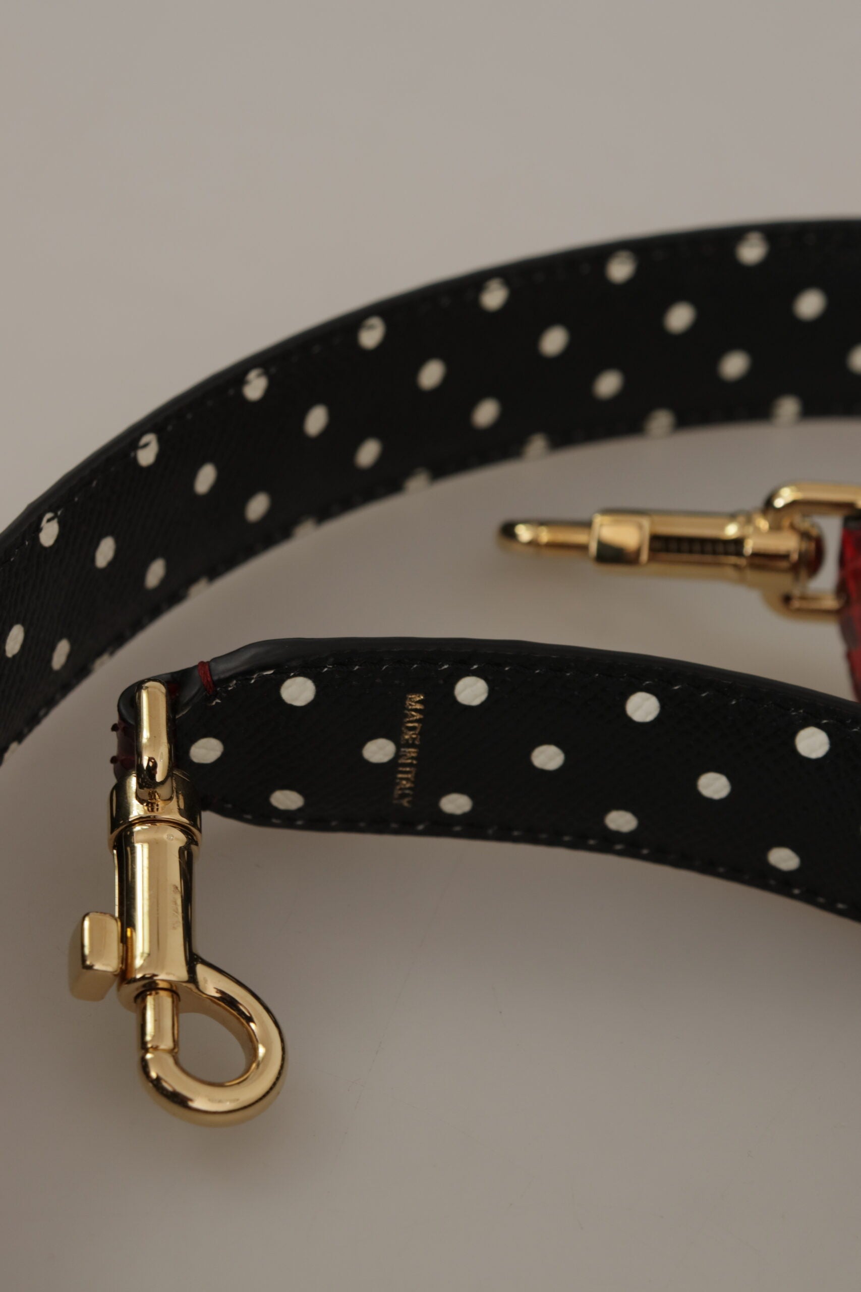 Shoulder Strap by Dolce & Gabbana for unisex in python leather & crystal black, gold & red showcases a enviable design, perfect for elevating any ensemble as part of the Python Leather Crystal Shoulder Strap collection.