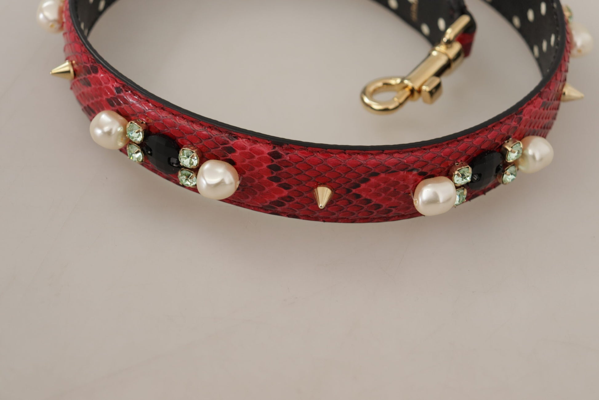 Shoulder Strap by Dolce & Gabbana for unisex in python leather & crystal cherry, gold & red features a effortlessly chic design, perfectly complementing the signature look of the Python Leather Crystal Shoulder Strap.