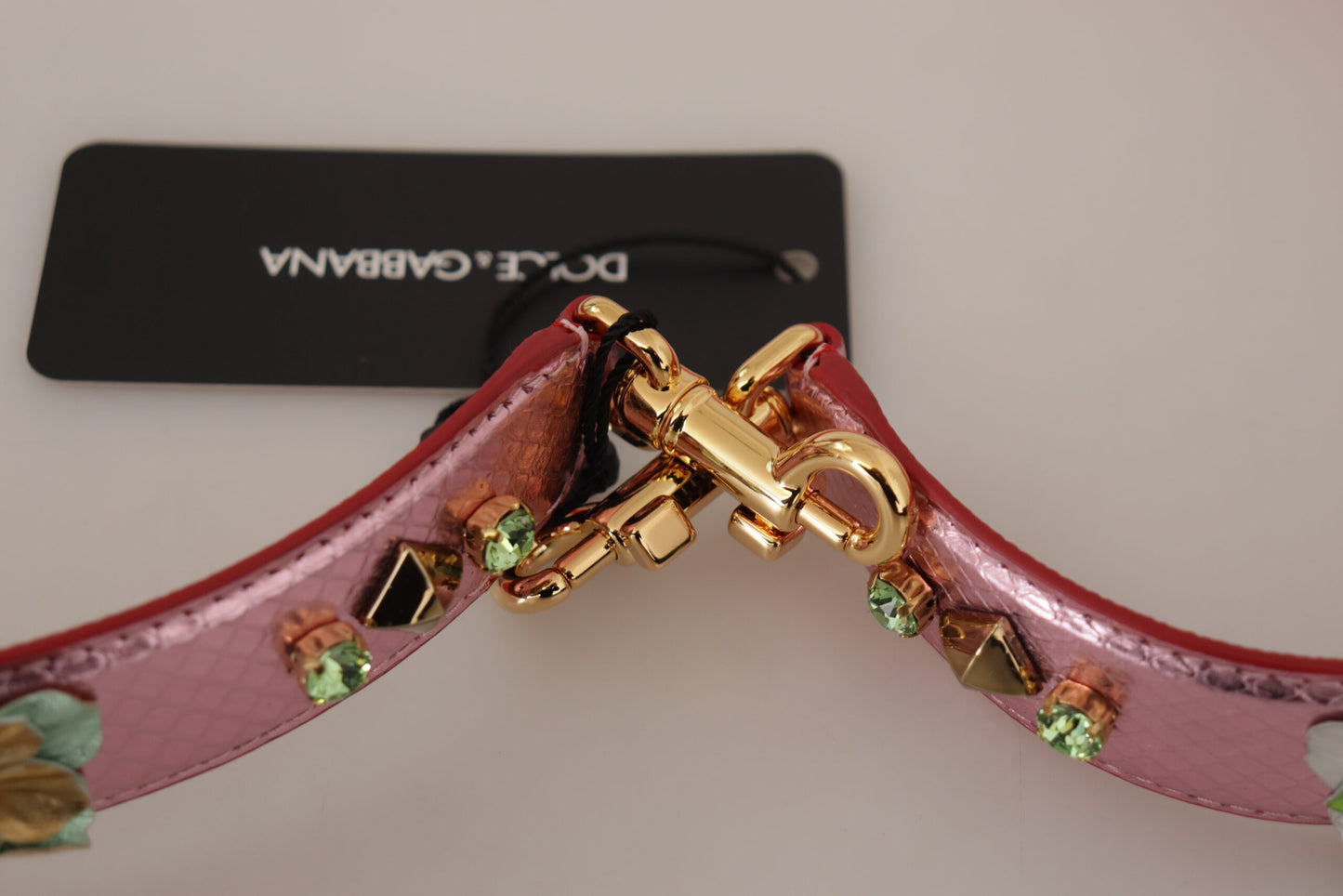 Shoulder Strap by Dolce & Gabbana for unisex in leather & metal gold & pink features a chic design, presenting a refined view of the Leather Metal Shoulder Strap with a chic finish.