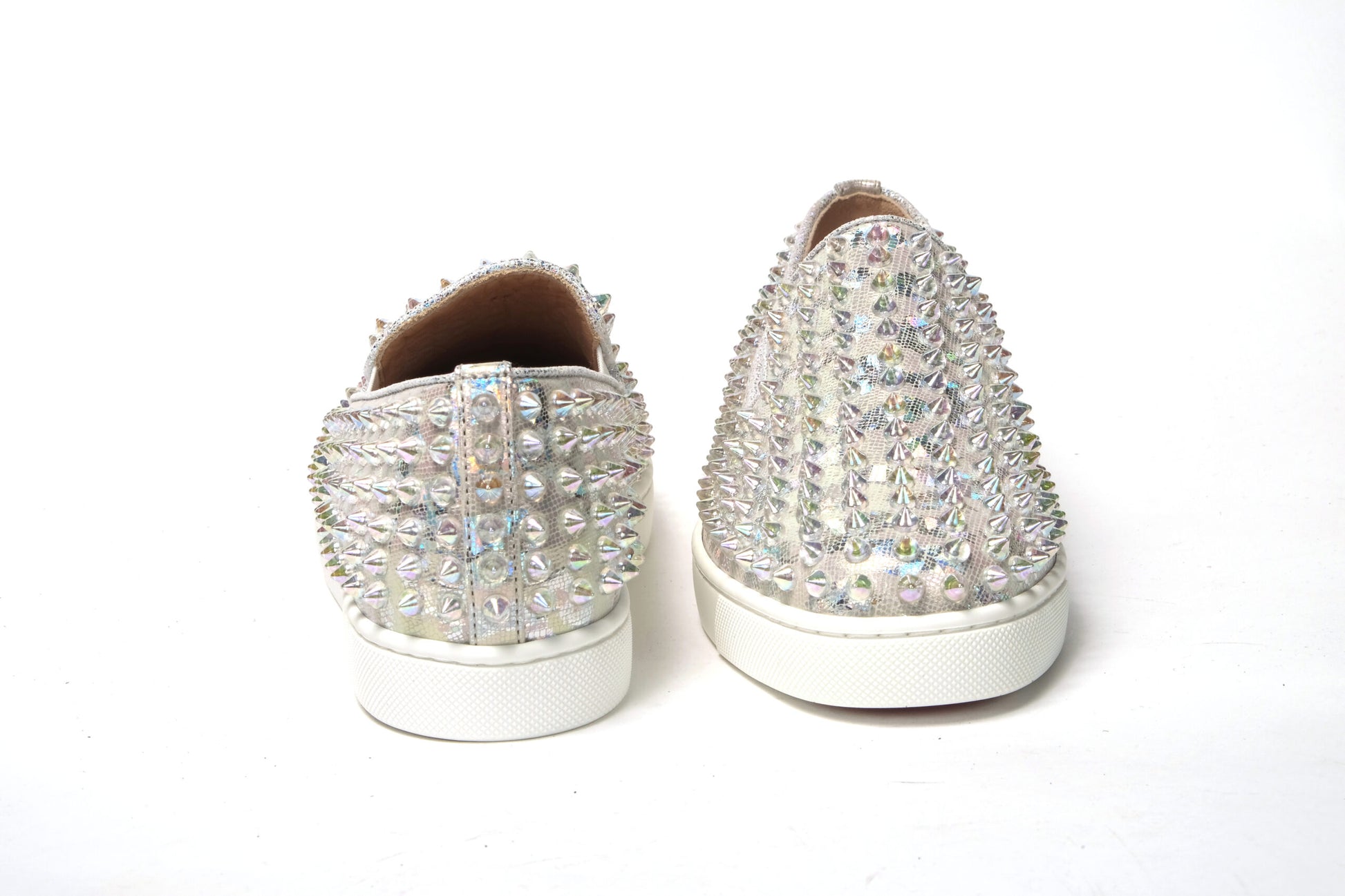 Sneakers by Christian Louboutin for women in calf leather white & signature presents a sumptuous silhouette, artfully capturing the essence of the Women's Slip On Calf Leather Sneakers with its sumptuous slip-on style design.