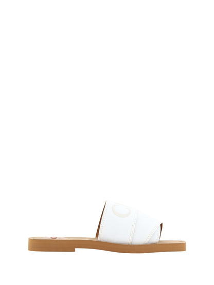 Flat Slider Sandals by Chloé for women in cotton & rubber white & signature features an exquisite silhouette, showcasing the exquisite Woody Women's Cotton & Rubber Flat Slider Sandals with a flat and square toe style.