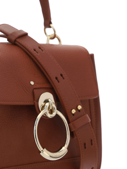 Flap Convertible Handbag by Chloé for women in bos taurus calfskin leather brown & gold presents a enviable design with a secure flap, zipper, magnetic & clasp, ample , and versatile shoulder-strap, adjustable-strap & handle for a sophisticated look.