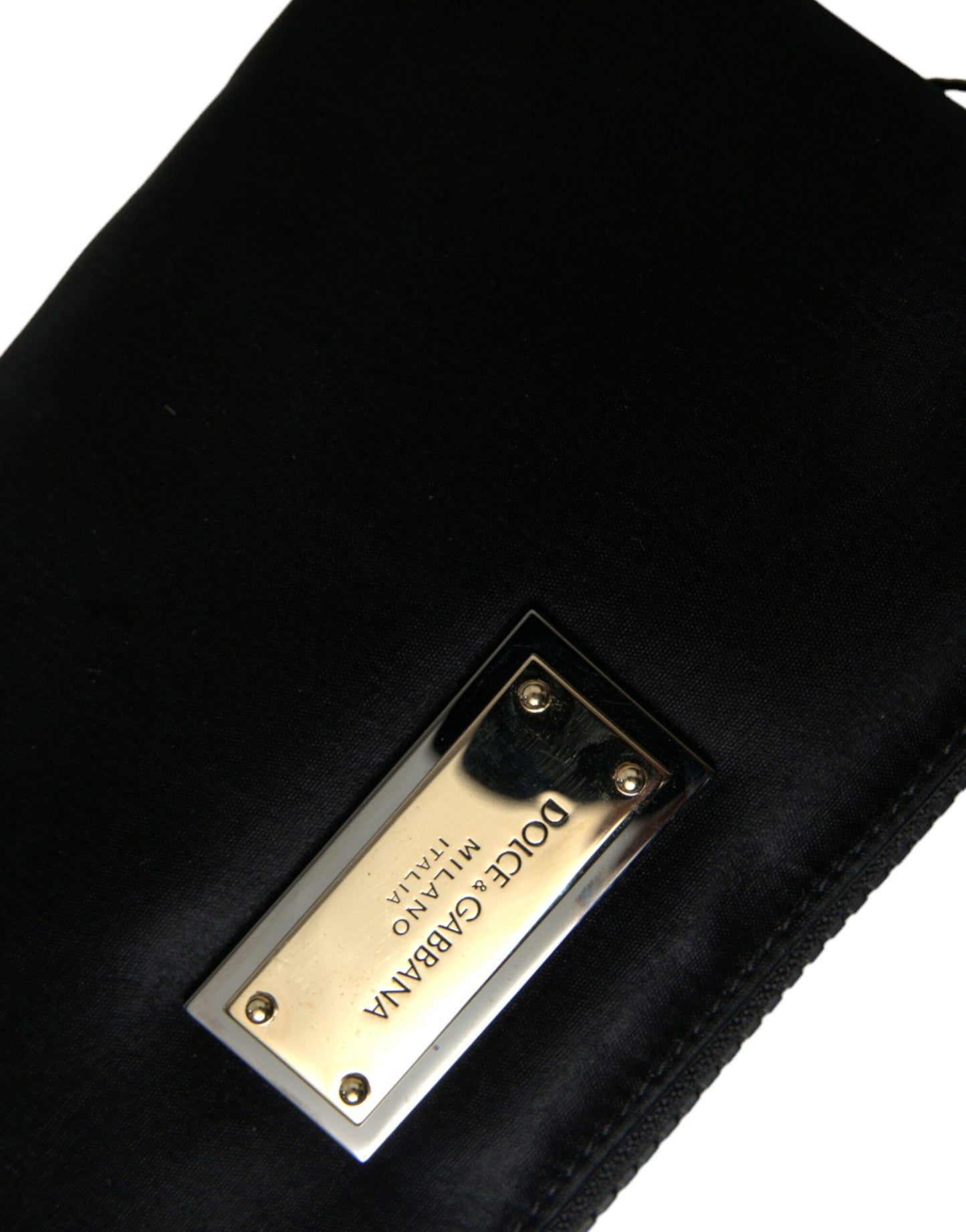Compact Pouch Clutch Handbag by Dolce & Gabbana for women in calfskin leather & nylon black & silver features a sculptural silhouette with a secure zipper, ample , and versatile detachable-strap for a sculptural finish.
