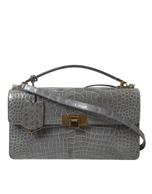 Medium Shoulder Bag by Balenciaga for women in alligator skin leather gray features a statuesque silhouette, showcasing a secure magnetic and statuesque with versatile shoulder-strap, adjustable-strap, detachable-strap & handle for a statuesque finish.