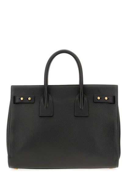 Box Handbag by Saint Laurent for women in pebbled calf leather black & print features a signature silhouette, showcasing a secure zipper and signature built-in-compartments with versatile shoulder-strap, adjustable-strap, detachable-strap & handle for a sophisticated look.