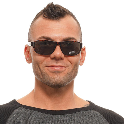 Sunglasses by Guess for unisex in and brown presents a sumptuous silhouette, featuring brown coloured frame and rectangle full-rim frame design with non-polarized category-3-dark-tint lens for a sumptuous look.