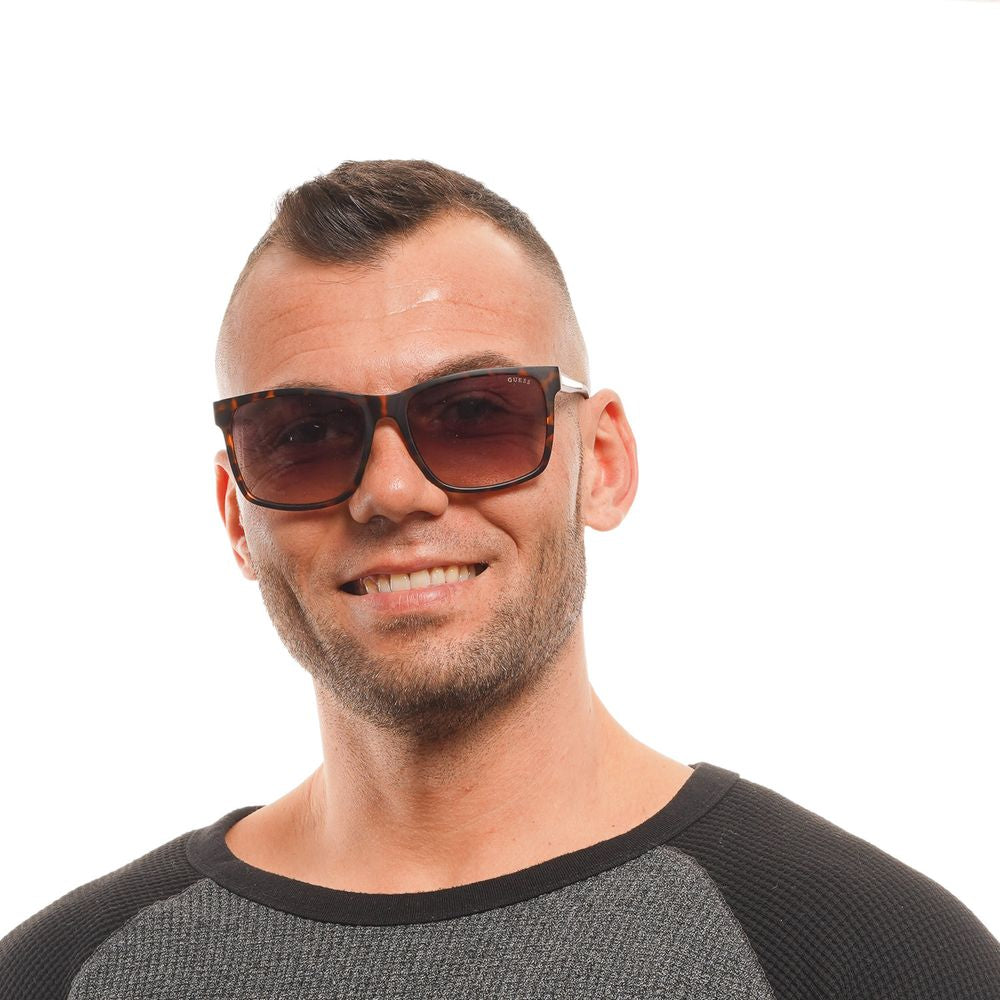Sunglasses by Guess for men in and brown presents a sumptuous silhouette, featuring brown coloured frame and full-rim square frame design with gradient category-3-dark-tint lens for a sumptuous look.