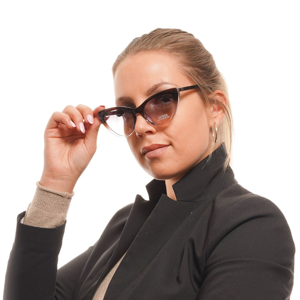 Sunglasses by Guess for women in brown showcases a ethereal silhouette, featuring brown coloured frame full-rim cat-eye frame design with gradient category-2-medium-tint lens for a ethereal finish.