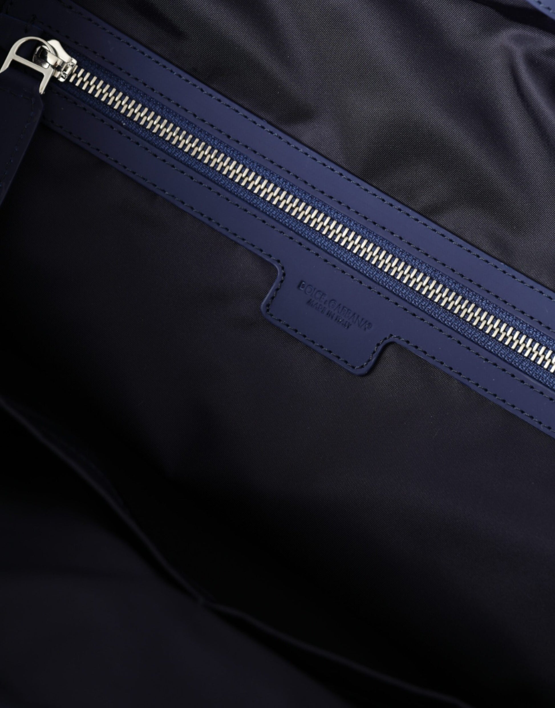 Travel Duffel Bag by Dolce & Gabbana for men in calfskin leather & nylon black & blue presents a refined silhouette from the Calfskin Leather Nylon Travel Duffel Bag collection, featuring a refined zipper, ample internal-pockets, and versatile shoulder-strap, handle, adjustable-strap & detachable-strap.