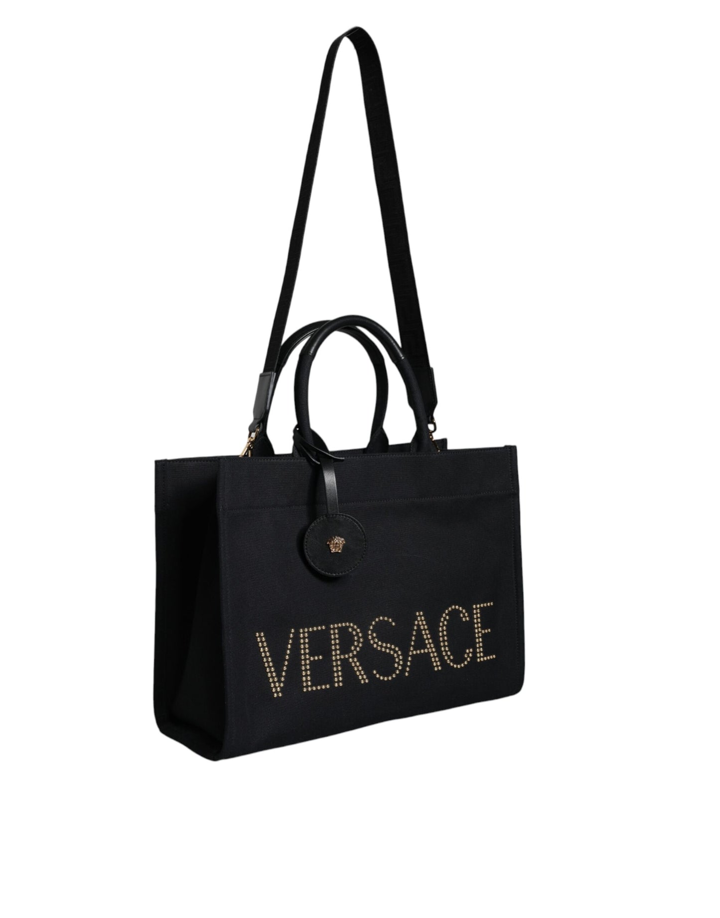 This Crossbody Tote Bag by Versace for women in canvas & leather black features an jet-set Canvas & Leather Crossbody Tote Bag design with a secure zipper, ample , and jet-set crossbody-strap, shoulder-strap, handle, adjustable-strap & detachable-strap.