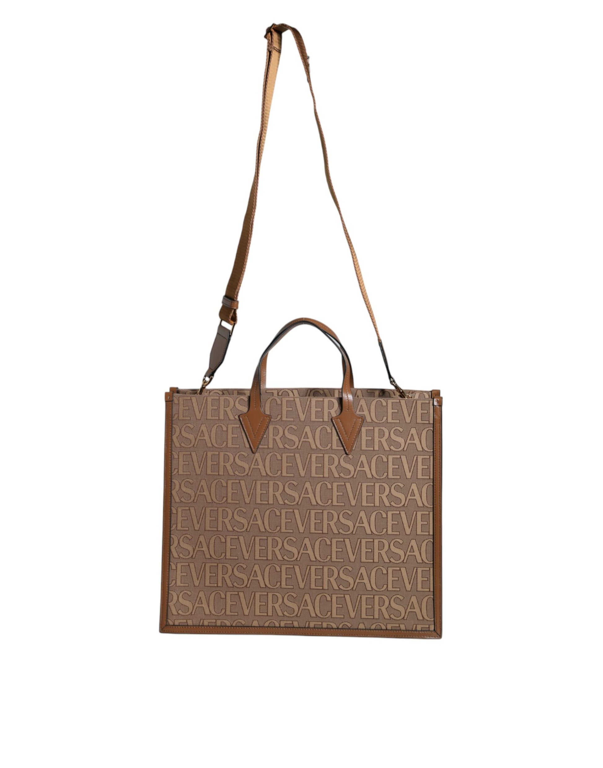 Crossbody Tote Bag by Versace for women in leather & cotton brown, white & jacquard features a jet-set sophisticated Leather & Cotton Crossbody Tote Bag design with a secure zipper, ample , and versatile crossbody-strap, shoulder-strap, handle, adjustable-strap & detachable-strap for a jet-set sophisticated finish.