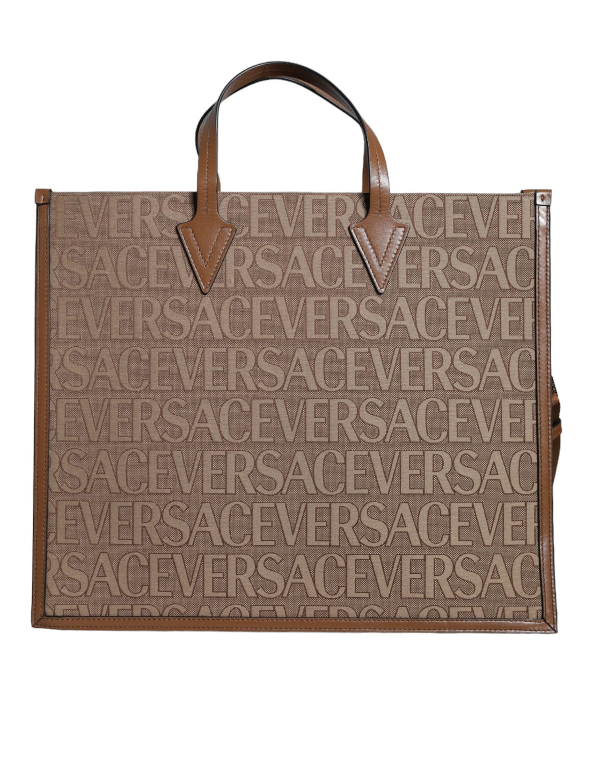This Crossbody Tote Bag by Versace for women in leather & cotton brown, white & jacquard features an jet-set Leather & Cotton Crossbody Tote Bag design with a secure zipper, ample , and jet-set crossbody-strap, shoulder-strap, handle, adjustable-strap & detachable-strap.