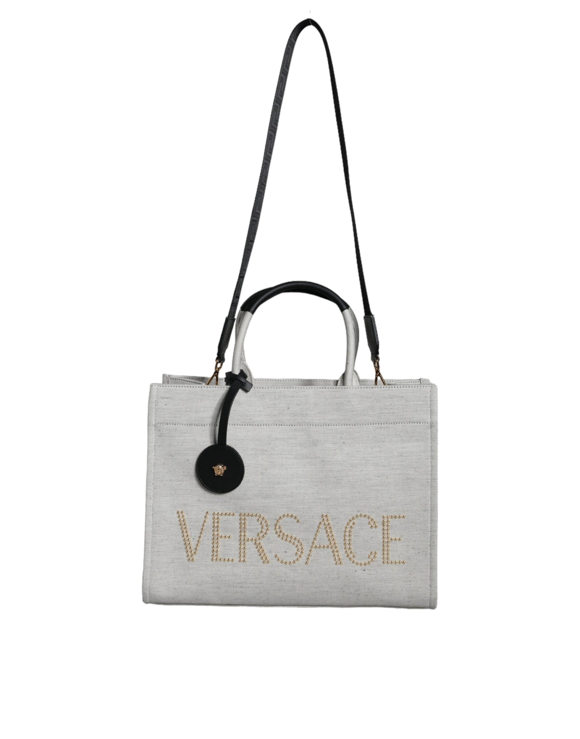 Crossbody Tote Bag by Versace for women in leather & canvas black & white features an jet-setting Crisp Leather & Canvas Crossbody Tote Bag design with a secure zipper, jet-setting , and versatile crossbody-strap, shoulder-strap, handle, adjustable-strap & detachable-strap for a jet-setting look.