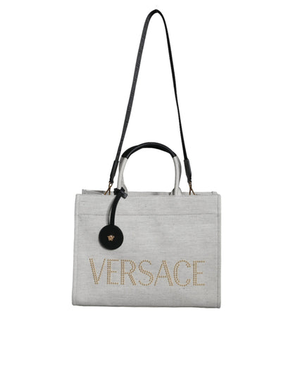 Crossbody Tote Bag by Versace for women in leather & canvas black & white features an jet-setting Crisp Leather & Canvas Crossbody Tote Bag design with a secure zipper, jet-setting , and versatile crossbody-strap, shoulder-strap, handle, adjustable-strap & detachable-strap for a jet-setting look.