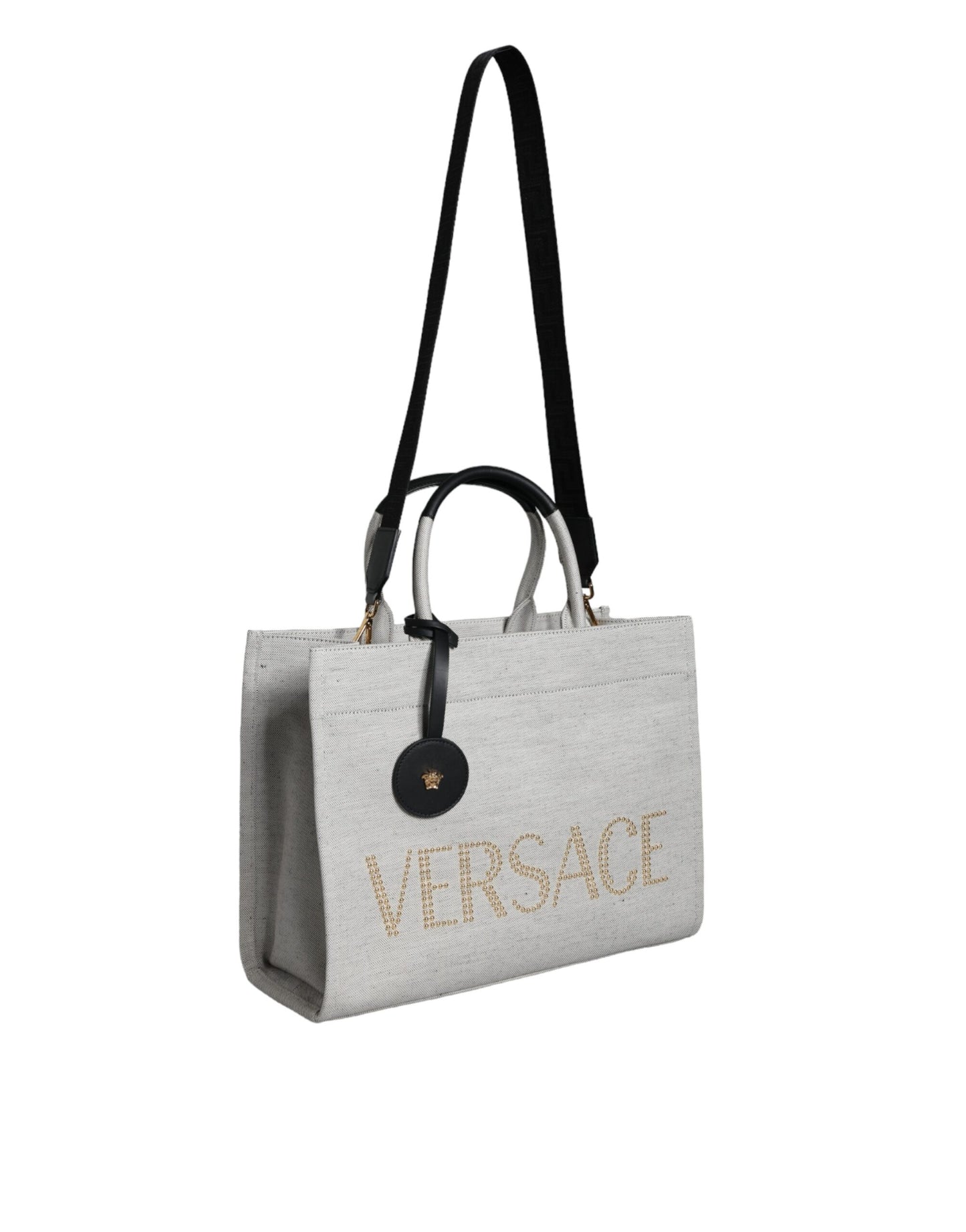 This Crossbody Tote Bag by Versace for women in leather & canvas black & white features an jet-set Crisp Leather & Canvas Crossbody Tote Bag design with a secure zipper, ample , and jet-set crossbody-strap, shoulder-strap, handle, adjustable-strap & detachable-strap.