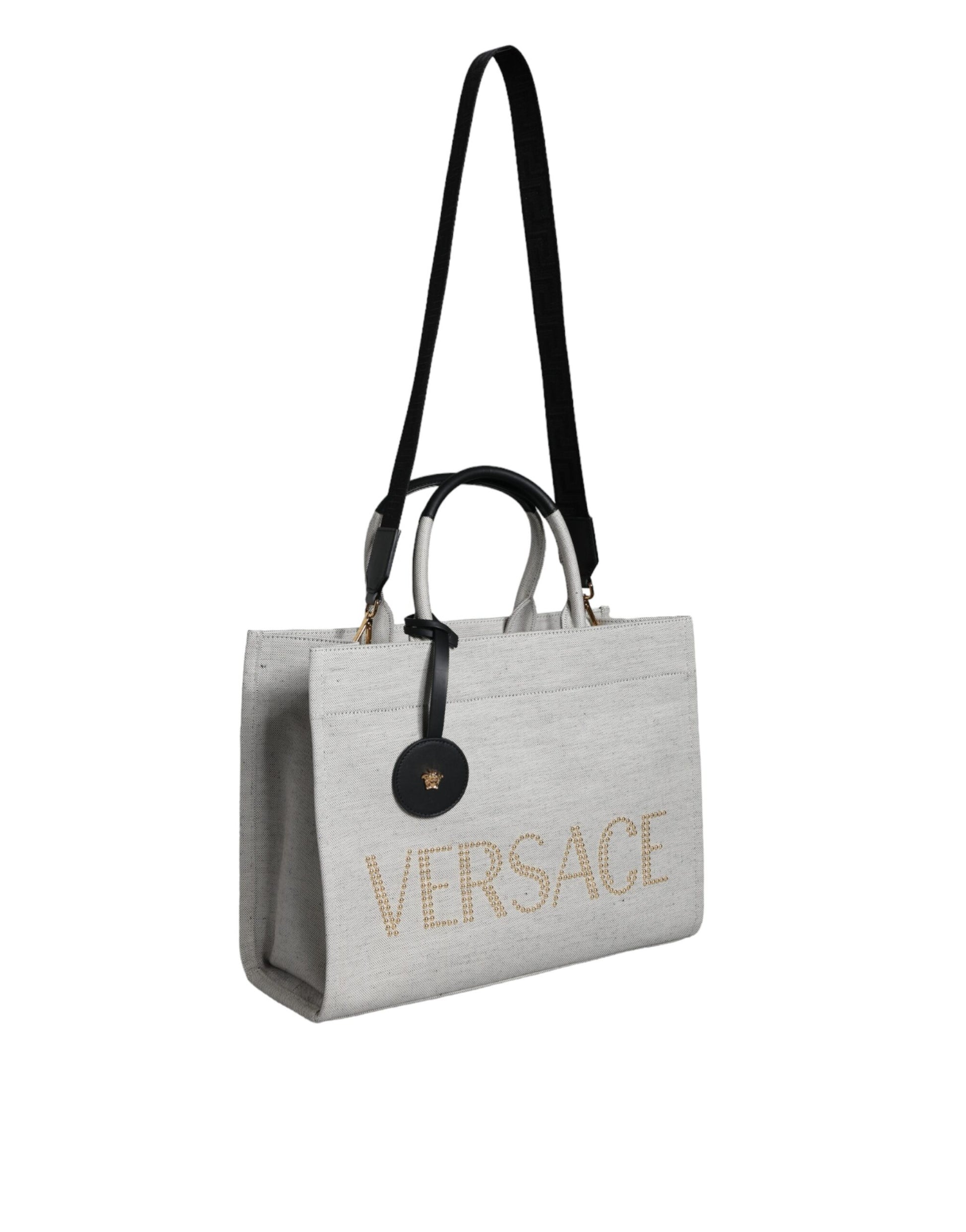 This Crossbody Tote Bag by Versace for women in leather & canvas black & white features an jet-set Crisp Leather & Canvas Crossbody Tote Bag design with a secure zipper, ample , and jet-set crossbody-strap, shoulder-strap, handle, adjustable-strap & detachable-strap.