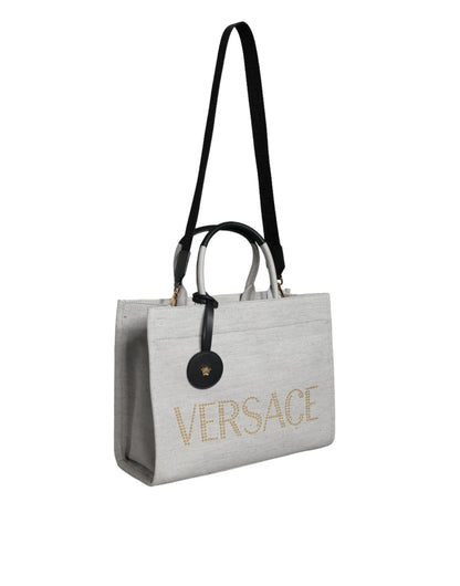 This Crossbody Tote Bag by Versace for women in leather & canvas black & white features an jet-set Crisp Leather & Canvas Crossbody Tote Bag design with a secure zipper, ample , and jet-set crossbody-strap, shoulder-strap, handle, adjustable-strap & detachable-strap.