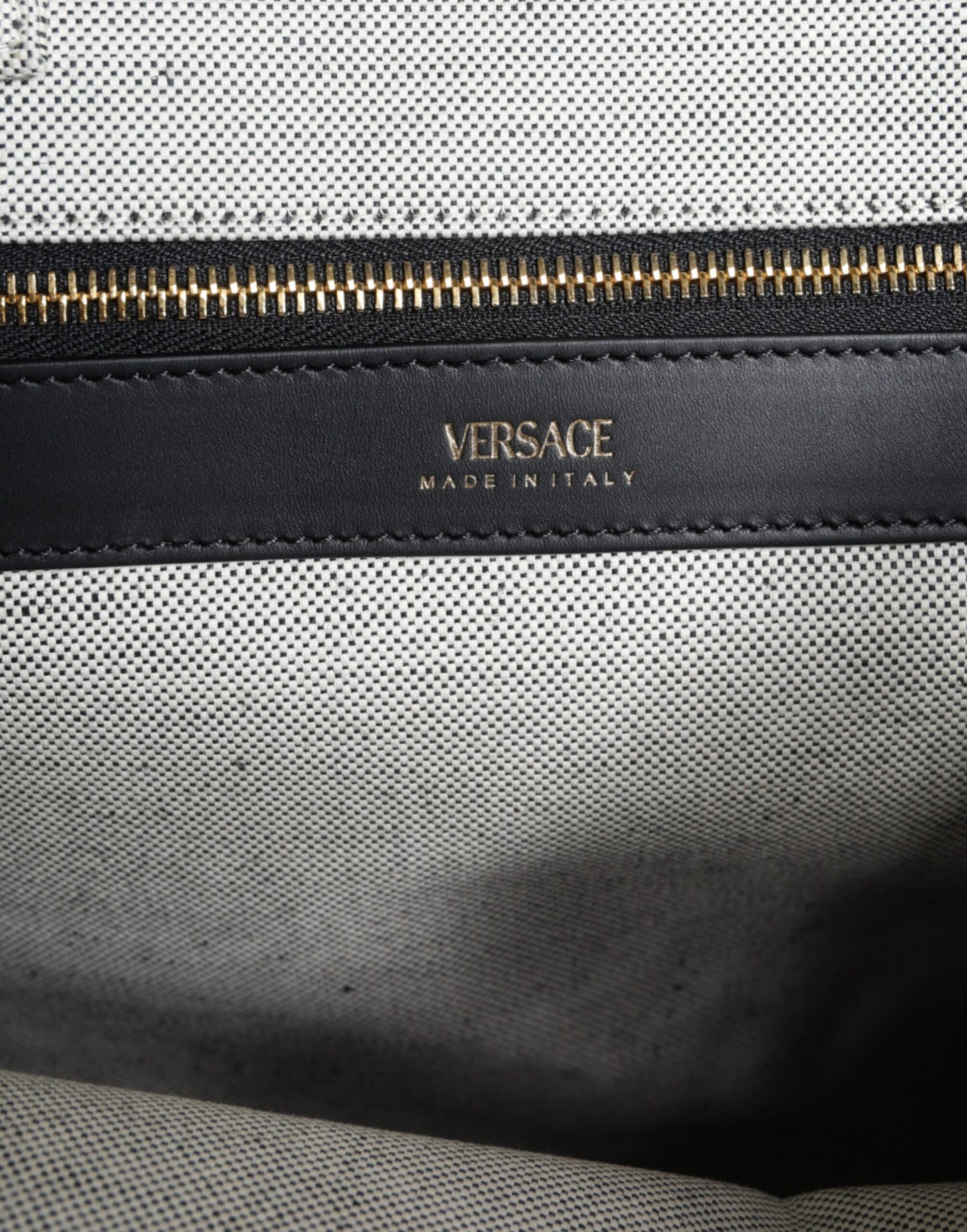 Crossbody Tote Bag by Versace for women in leather & canvas black & white features an jet-set Crisp Leather & Canvas Crossbody Tote Bag design with a secure zipper, ample , and versatile crossbody-strap, shoulder-strap, handle, adjustable-strap & detachable-strap for an jet-set finish.