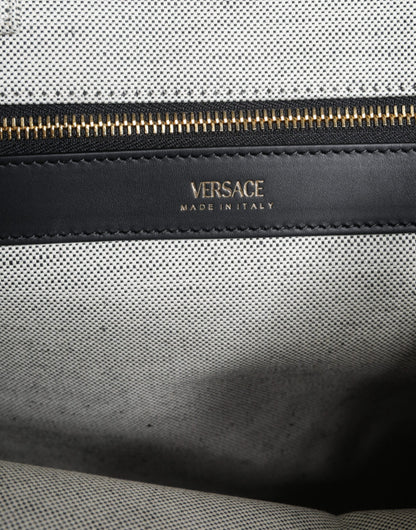 Crossbody Tote Bag by Versace for women in leather & canvas black & white features an jet-set Crisp Leather & Canvas Crossbody Tote Bag design with a secure zipper, ample , and versatile crossbody-strap, shoulder-strap, handle, adjustable-strap & detachable-strap for an jet-set finish.