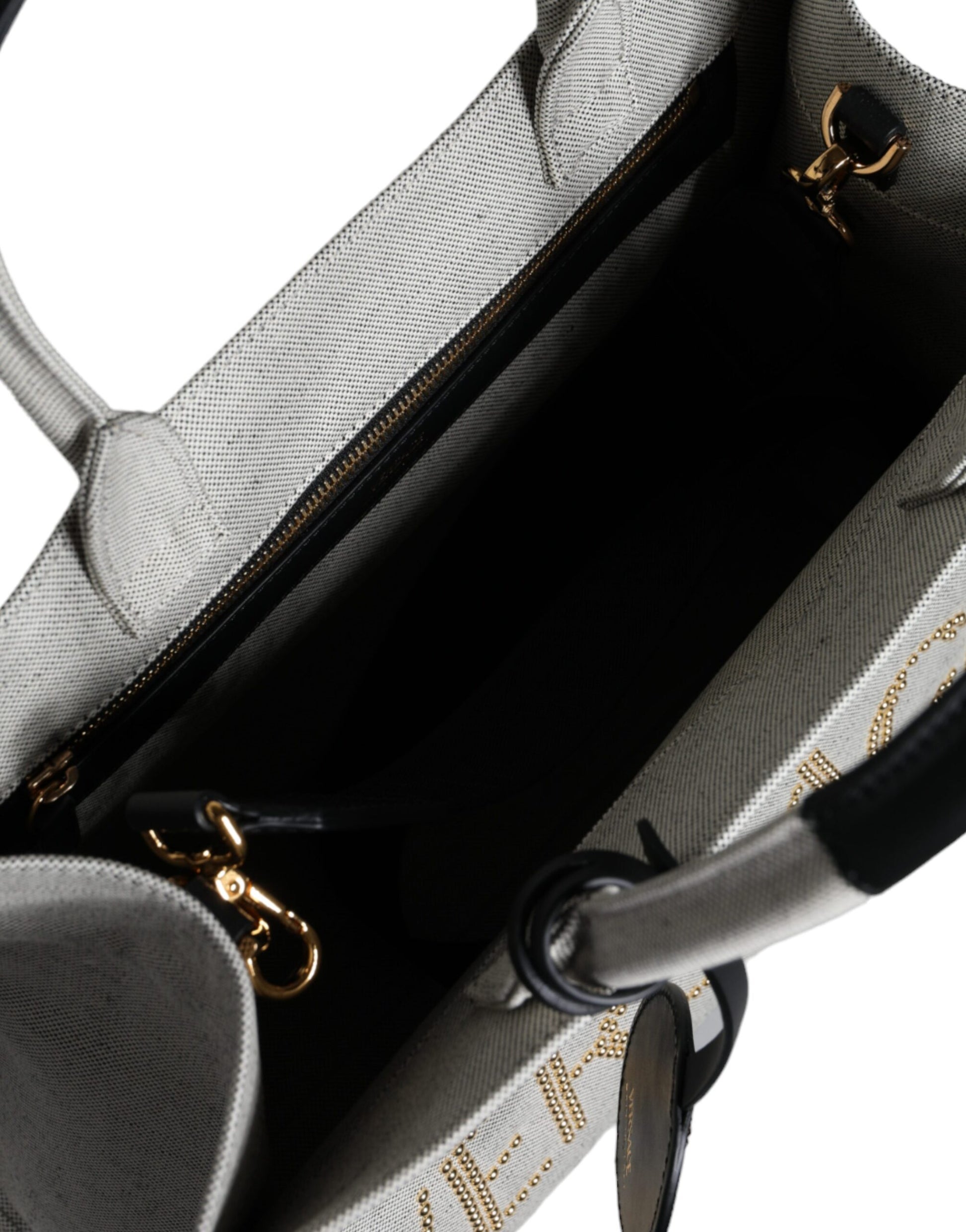 Crossbody Tote Bag by Versace for women in leather & canvas black & white features a jet-set Crisp Leather & Canvas Crossbody Tote Bag design, complete with a secure zipper, ample , and versatile crossbody-strap, shoulder-strap, handle, adjustable-strap & detachable-strap for a jet-set look.
