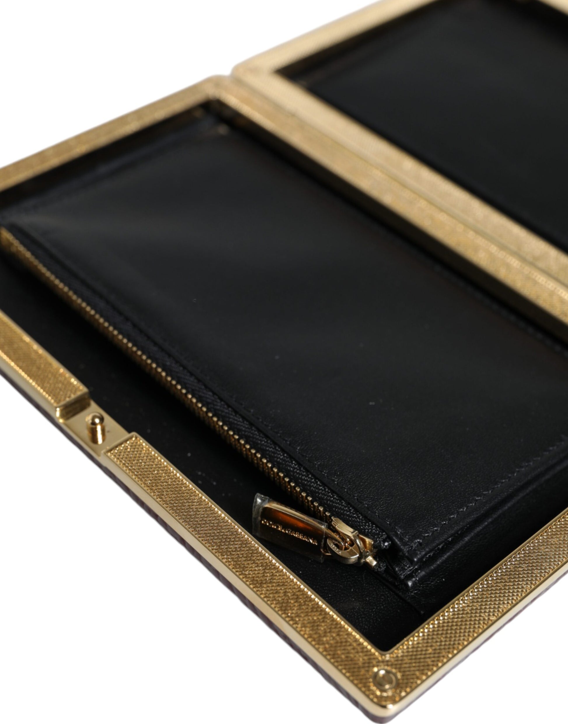 Compact Evening Crossbody Box Clutch Convertible Handbag by Dolce & Gabbana for women in leather & brass black, gold & maroon features an exquisite silhouette, showcasing a secure , ample cardholder, and exquisite crossbody-strap for a sophisticated finish.