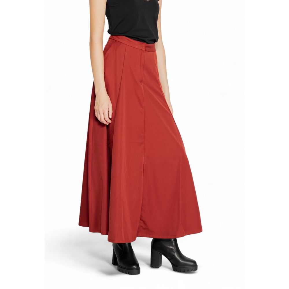 Skirt by Vero Moda for women in polyester red showcases a dramatic silhouette, artfully capturing the essence of the Women's Polyester Skirt in a dramatic cut for a refined look.