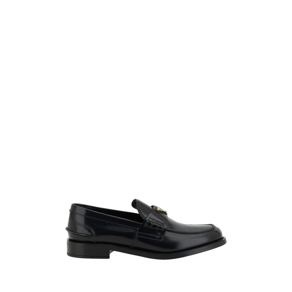 Loafers Flat Shoes by Prada for women in leather black & signature showcases a sculptural silhouette as part of the Grace Women's Leather Loafers Flat Shoes collection, defined by a sculptural round toe style and for a sculptural look.