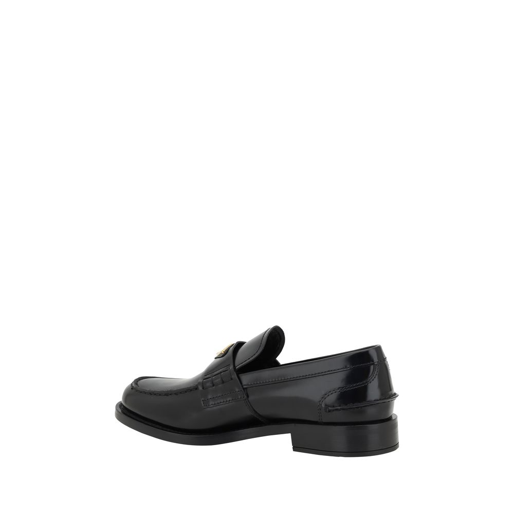 Loafers Flat Shoes by Prada for women in leather black & signature features an stately silhouette, showcasing the stately style of the Grace Women's Leather Loafers Flat Shoes with its distinct and refined round toe style.