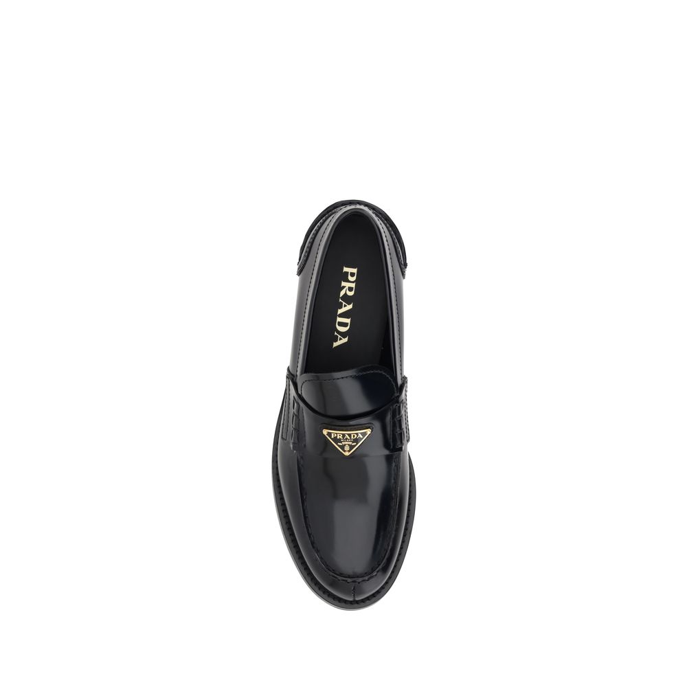 Loafers Flat Shoes by Prada for women in leather black & signature presents a stalwart silhouette, showcasing the Grace Women's Leather Loafers Flat Shoes design with a stalwart and round toe style for a sophisticated look.