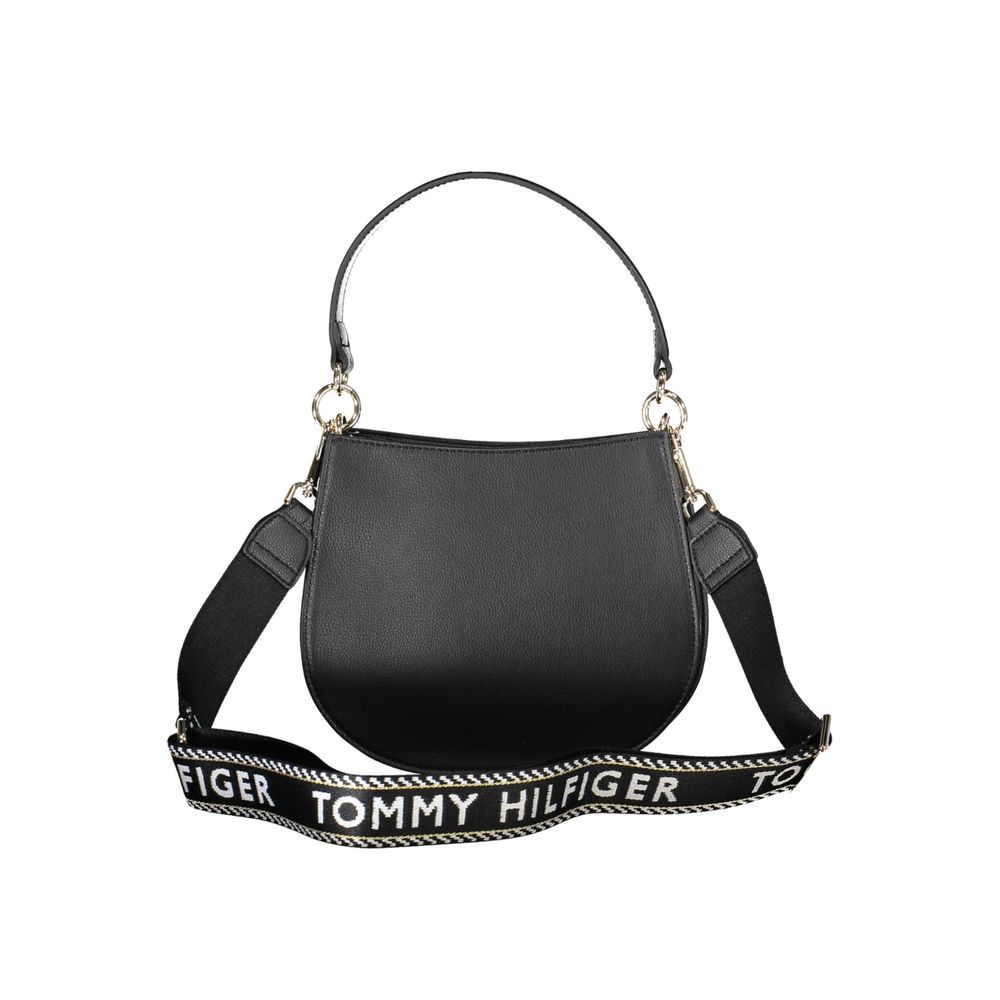 Crossbody Evening Convertible Handbag by Tommy Hilfiger for women in polyester polyethylene faux leather black features a exquisite silhouette with a secure zipper, ample built-in-compartments, and versatile crossbody-strap, shoulder-strap, adjustable-strap & handle for a exquisite look.