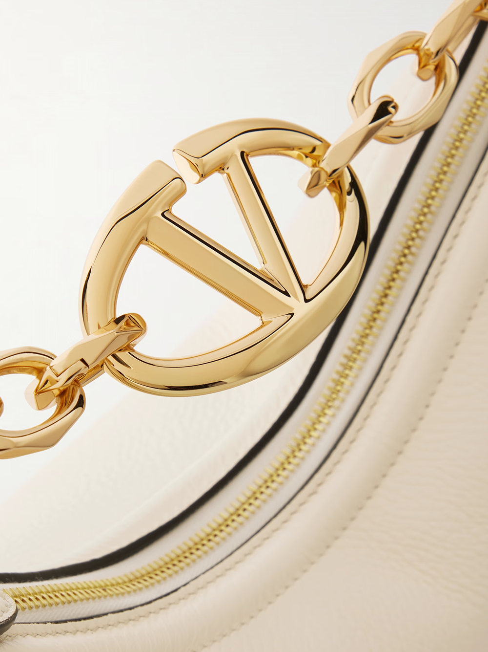 Small 2-in-1 Shoulder & Crossbody Hobo Convertible Handbag by Valentino Garavani for women in calfskin leather black, ivory & signature presents a exquisite silhouette, showcasing a secure and organized with versatile crossbody-strap & shoulder-strap.