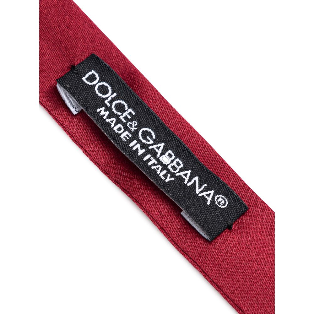 Necktie by Dolce & Gabbana for men in silk burgundy & red features a sun-drenched silhouette, showcasing the sun-drenched design of this Silk Necktie with a sun-drenched finish.