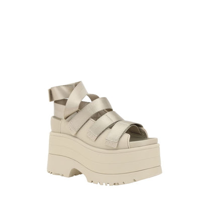 Platform Sandals by UGG for women in rubber beige features an architectural silhouette, showcasing the architectural Women's Rubber Platform Sandals with a platform and round toe style.