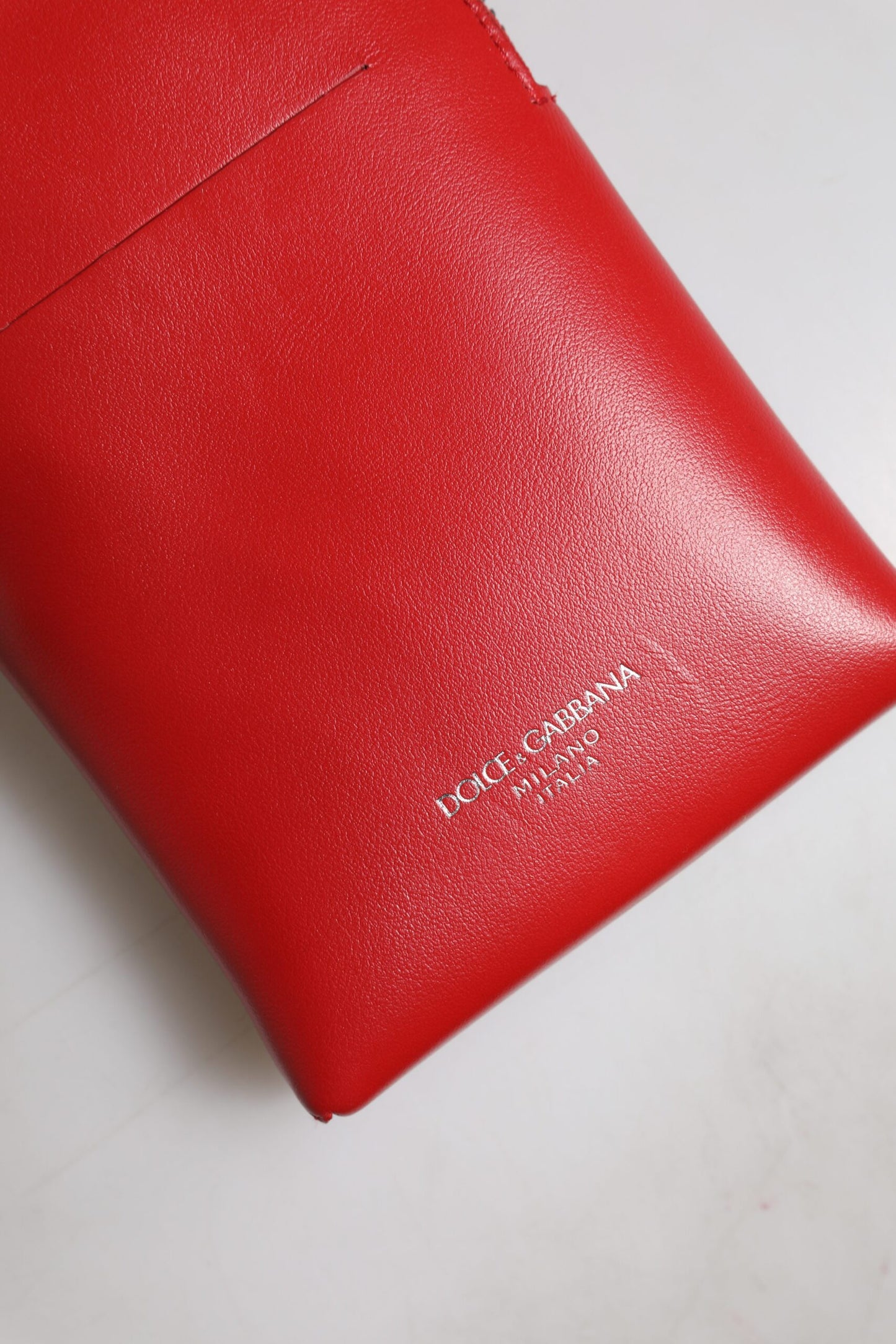 Adjustable Crossbody Shoulder & Sling Bag by Dolce & Gabbana for men in leather & metal red showcases a statuesque silhouette, artfully detailed with a secure zipper, organized , and versatile crossbody-strap & shoulder-strap for a statuesque look.