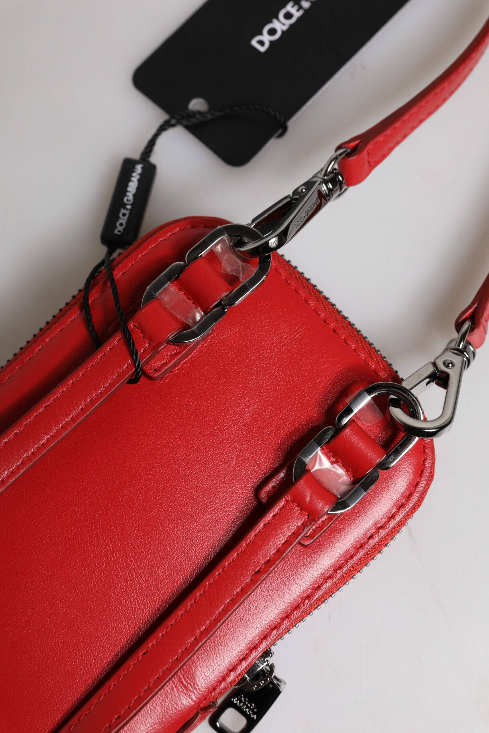 Adjustable Crossbody Shoulder & Sling Bag by Dolce & Gabbana for men in leather & metal red features an effortlessly chic silhouette with a secure zipper, ample , and versatile crossbody-strap & shoulder-strap for effortlessly chic everyday luxury.