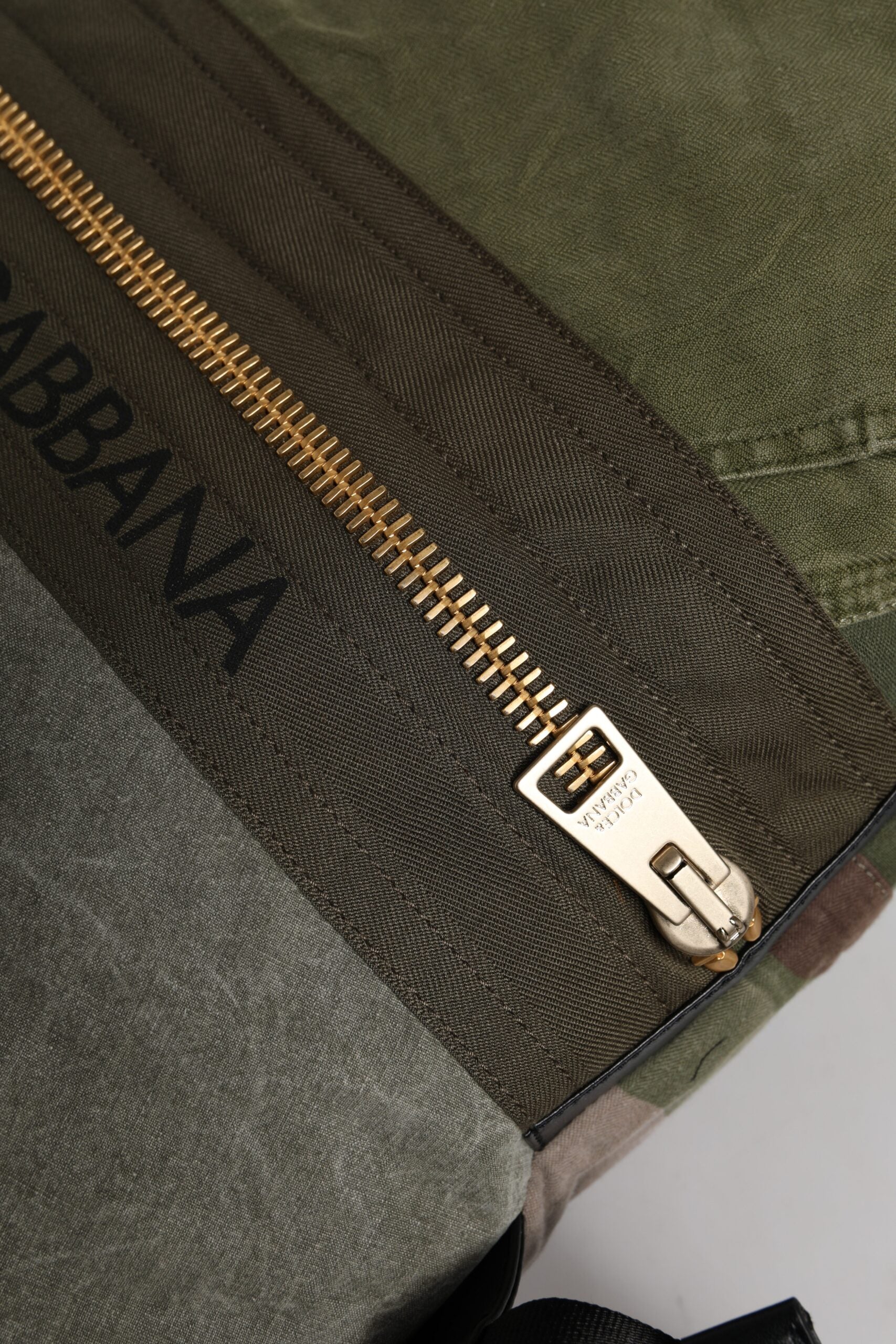 Large Drawstring Rucksack Backpack by Dolce & Gabbana for men in calf leather & cotton military-green, camouflage & patchwork showcases an architectural Calf Leather Cotton Large Drawstring Rucksack Backpack design, featuring a secure drawstring, ample internal-pockets, and architectural backpack-strap for a sophisticated look.
