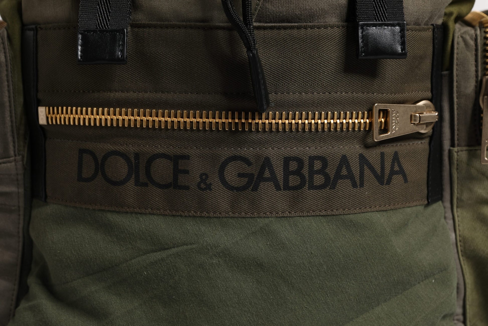 Large Travel Drawstring Backpack by Dolce & Gabbana for men in calf leather & cotton military-green, camouflage & patchwork showcases an architectural Calf Leather Cotton Large Travel Drawstring Backpack design, featuring a secure drawstring, ample internal-pockets, and architectural backpack-strap for a sophisticated look.